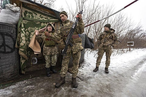 Ukrainian servicemen guard a checkpoint at the line of separation in the Luhansk region, in Luhansk, Ukraine, Thursday, Feb. 3, 2022. (Photo | AP)