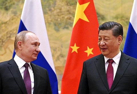 Chinese President Xi Jinping, right, and Russian President Vladimir Putin talk to each other during their meeting in Beijing, China. (Photo | AP)