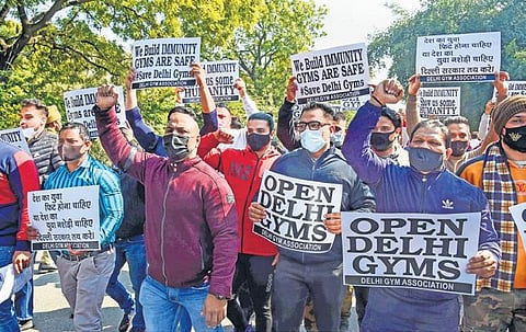 Gym owners raise slogans during a protest seeking opening of gyms. (File Photo | PTI)