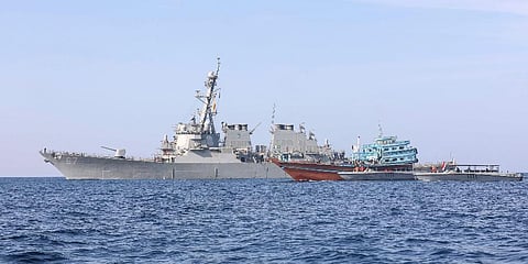 Guided-missile destroyer USS Cole is seen as its sailors transfer control of a stateless fishing vessel to the Yemen Coast Guard in the Gulf of Oman, Jan. 21, 2022. (Photo | AP)
