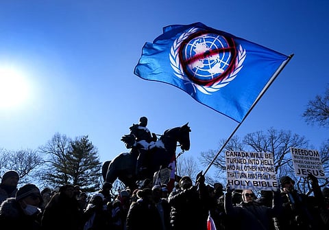 People protest in support of a trucker convoy protesting COVID-19 restrictions, at Queen's Park in Toronto. (Photo | AP)