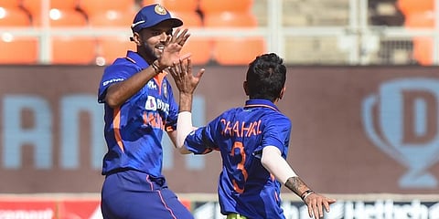 Yuzvendra Chahal (R) celebrates with Washington Sundar the wicket of West Indies captain Kieron Pollard during the first ODI cricket match between India and West Indies, Feb 6, 2022. (Photo | PTI)