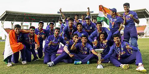 Indian cricket team players pose with the World Cup trophy after beating England in the U19 World Cup finals at Sir Vivian Richards Stadium in Antigua, West Indies, Feb 6, 2022. (Photo | PTI)