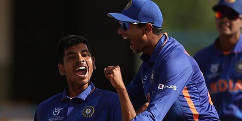 India's Ravi Kumar, left, celebrates with a teammate after a wicket U19 World Cup final cricket match between India and England, Feb 5, 2022. (Photo | PTI)