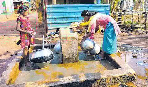 Villagers collecting water from a stand post in the village. (Photo | Express)