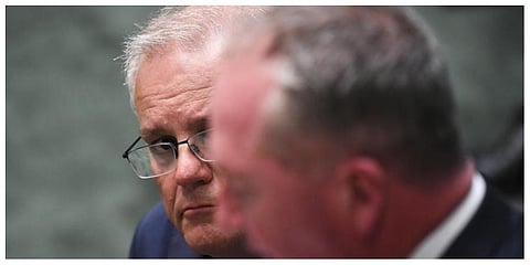 Australian Prime Minister Scott Morrison, rear, listens to Australian Deputy Prime Minister Barnaby Joyce at Parliament House in Canberra on Tuesday. (Photo: AP)