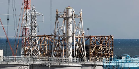 FILE - The damaged Unit 1 reactor, back, and the exhaust stack shared with the Unit 1 and 2 reactors at the Fukushima Daiichi nuclear power plant, Feb 27, 2021. (Photo | AP)