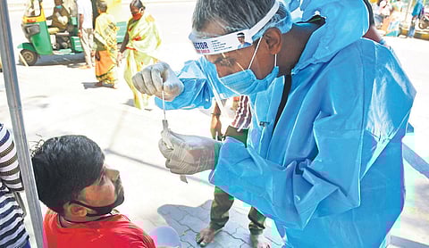 A health worker collects swab samples in Bengaluru on Tuesday | Shriram BN