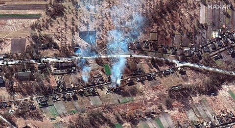 This satellite image provided by Maxar Technologies shows part of military convoy and burning homes northwest of Invankiv, Ukraine Monday. ( Photo | AP)