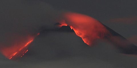 Lava flows down from the crater of Mount Merapi seen from Pakembinangun village in Sleman, Central Java, Thursday, March 10, 2022. (Photo | AP)
