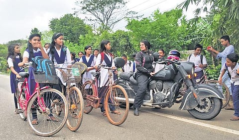 With a bunch of girls cycling back from school