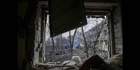 Ukrainian emergency employees work at the side of the damaged by shelling maternity hospital in Mariupol, Ukraine, Wednesday, March 9, 2022.(Photo | AP)