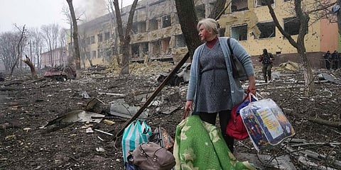 A woman stands outside the maternity hospital damaged by shelling in Mariupol, Ukraine, Wednesday, March 9, 2022. (Photo | AP)