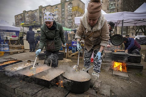 People cook outdoors for Ukrainian servicemen and civil defense members serving in Kyiv, Ukraine, Monday, March 7, 2022. (Photo | AP)