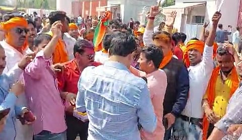 People celebrate BJP victory in Uttar Pradesh.