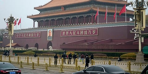 Security officers stand guard near Tiananmen Gate before the closing session of China's National People's Congress (NPC) at the Great Hall of the People in Beijing, Friday, March 11, 2022. (Photo | AP