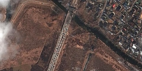 This satellite image provided by Maxar Technologies shows a long line of people and cars waiting by the damaged Irpin River bridge in Irpin, Ukraine, March 10, 2022. (Photo | AP)
