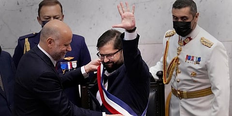 Chile's new President Gabriel Boric receives the presidential sash from Congress President Alvaro Elizalde during his swearing-in ceremony at Congress in Valparaiso, Chile, Mar 11, 2022. (Photo | AP)