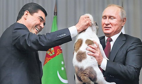 Putin (right) receives a Turkmen shepherd dog, locally known as Alabay, from Turkmenistan’s President Berdimuhamedow in Russia (file picture)