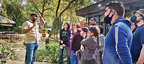 (L-R) Participants spot various birds at Buddha Jayanti Park; Walk leader Nikhil John shares information about the park with the participants