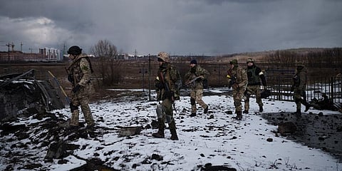 Ukrainian soldiers walk on a destroyed bridge in Irpin, on the outskirts of Kyiv, Ukraine, Tuesday, March 8, 2022. (Photo | AP)