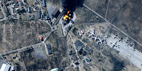 This multispectral satellite image provided by Maxar Technologies shows buildings and fuel storage tanks on fire at Antonov Airport, in Hostomel, Ukraine, March 11, 2022. (Photo | AP)