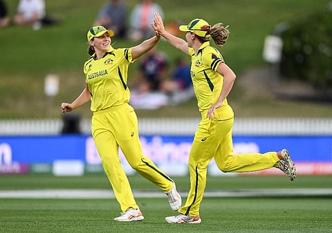 Darcie Brown of Australia, left, celebrates with team mate Annabel Sutherland after dismissing England's Lauren Winfield-Hill during the ICC Women's Cricket World Cup 2022. ( Photo | AP)
