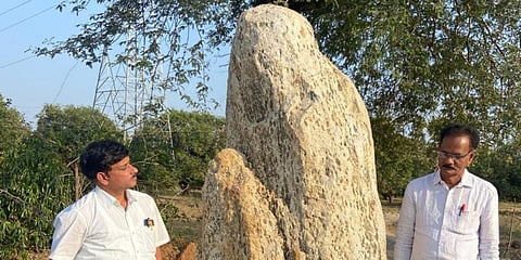 Archaeologists stand near the Menhir at Ellarigudem hamlet. (Photo| EPS)