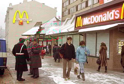 People walk past Moscow's first McDonalds a day before its opening, in Moscow's Pushkin Square, Jan. 30, 1990. (Photo | AP)