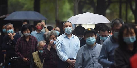 Residents line up for COVID-19 test in Hangzhou in eastern China's Zhejiang province Tuesday, March 15, 2022.(Photo | AP)