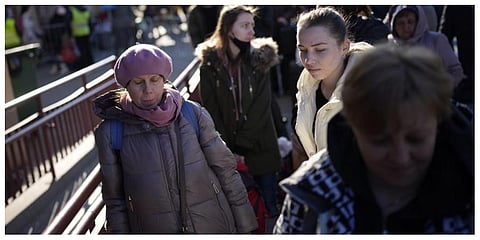 People wait in a line to board a train leaving for Lviv in Ukraine at the train station in Przemysl, Poland, Monday, March 14, 2022.  (Photo | AP)