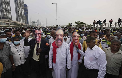 Supporters of Sri Lanka's main opposition wearing masks of President Gotabaya Rajapaksa, Prime Minster Mahinda Rajapaksaand Finance and Minister Basil Rajapaksa during a protest.(Photo | AP)