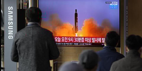 People watch a TV screen showing a news program reporting about North Korea's missile with file footage, at a train station in Seoul, South Korea, Wednesday, March 16, 2022. (Photo | AP)