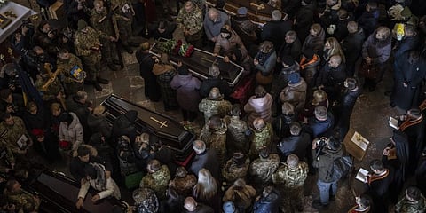 People attend a funeral ceremony for four of the Ukrainian military servicemen, who were killed during an airstrike in a military base in Yarokiv, in a church in Lviv, March 15, 2022.(Photo | AP)