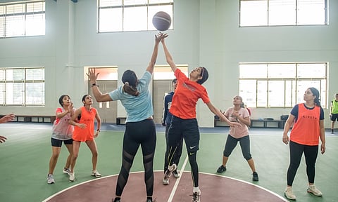 Members of Sisters in Sweat during a practice session of football and basketball