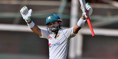 Mohammad Rizwan celebrates after completing 50 runs on the fifth day of the second test match between Pakistan and Australia at the National Stadium in Karachi. (Photo | AP)