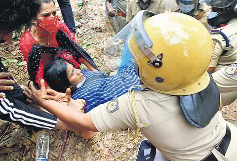 A woman protester is removed by police officers at Madappally in Changanassery on Thursday | Express