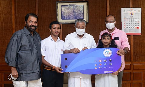 Chief Minister Pinarayi Vijayan releasing the new OS Suite by handing over a copy to M S Kalaveni of GHSS Cotton Hill and Akash J of St Joseph’s School, Thiruvananthapuram.