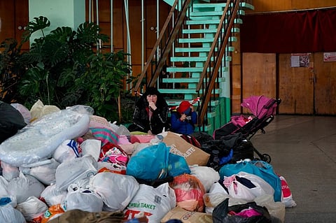 Evacuees from Mariupol wait at the Zaporizhzhya State Circus for transportation to other locations in the city of Zaporizhzhia on March 16, 2022. (AFP)