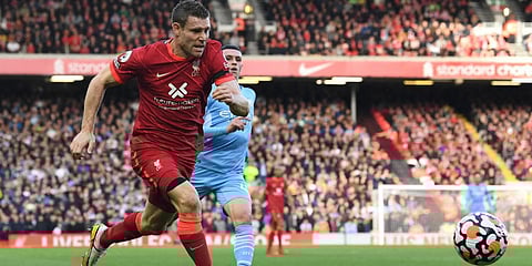 Liverpool's James Milner (L) challenges Manchester City's Phil Foden during an English Premier League match. (File photo| AFP)