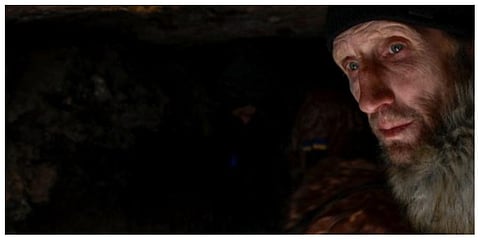 A man takes cover in a military trench as a Russian jet fighter flies over them next to the military school hit by Russian rockets the day before, in Mykolaiv on March 19, 2022. (Photo | AFP)