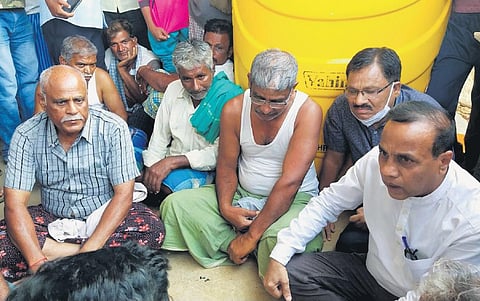 A grief-stricken Shekhar Gyana Goudar (centre) who lost his son Naveen amidst the Russia-Ukraine conflict in Kharkiv, at his residence in Chalageri on Tuesday | Express