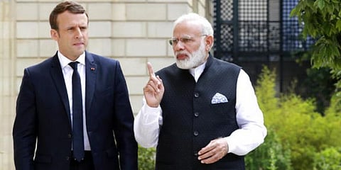 France President Emmanuel Macron (L) speaks with PM Narendra Modi. (File Photo | AP)