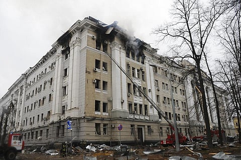 Firefighters extinguish a building of Ukrainian Security Service (SBU) after a rocket attack in Kharkiv, Ukraine's second-largest city. (Photo | AP)