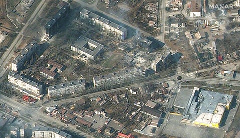 This satellite image provided by Maxar Technologies on Friday, March 18, 2022 shows damaged and burning apartment buildings and stores in Mariupol, Ukraine. (Photo | AP)