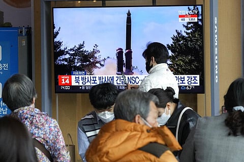 People watch a TV screen showing a file image of North Korea's rocket launch during a news program, at the Seoul Railway Station in Seoul, South Korea. (Photo | AP)