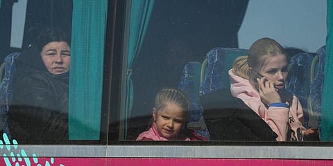 Refugees look out from a bus after fleeing the war from neighbouring Ukraine, at the border crossing in Palanca, Moldova. (Photo | AP)