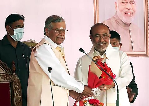 Manipur Governor La. Ganesan greets Manipur Chief Minister N Biren Singh after administering the oath of office to him, during swearing-in Ceremony, in Imphal on Monday. (Photo | ANI)
