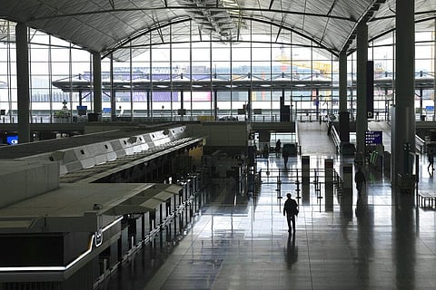 A man walks along an empty airport in Hong Kong, Friday, Feb. 18, 2022. (Photo | AP)