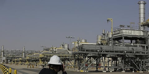 A photographer takes pictures of the Khurais oil field during a tour for journalists, 150 km east-northeast of Riyadh, Saudi Arabia, June 28, 2021. (Photo | AP)